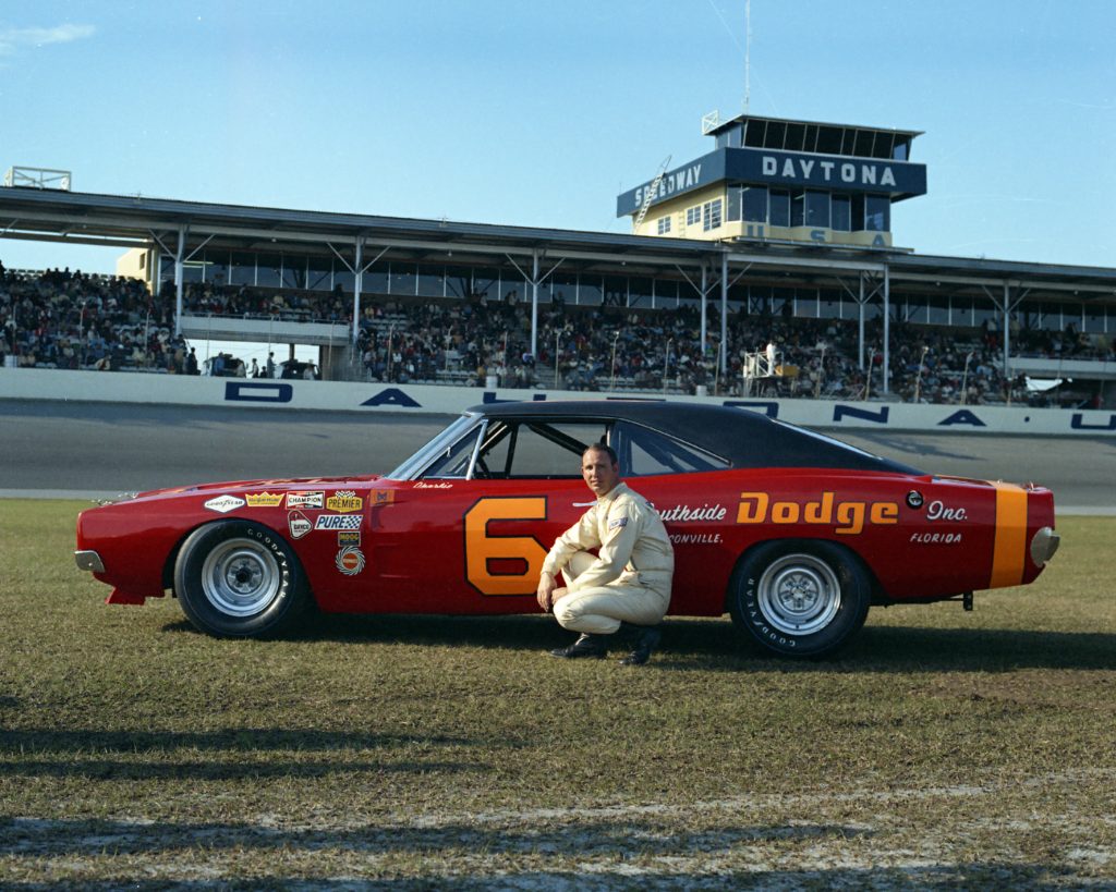 Charlie glotzbach kneels next to his #6 Cotton Owens Dodge for photos in February 1969, prior to the 1969 Daytona 500.